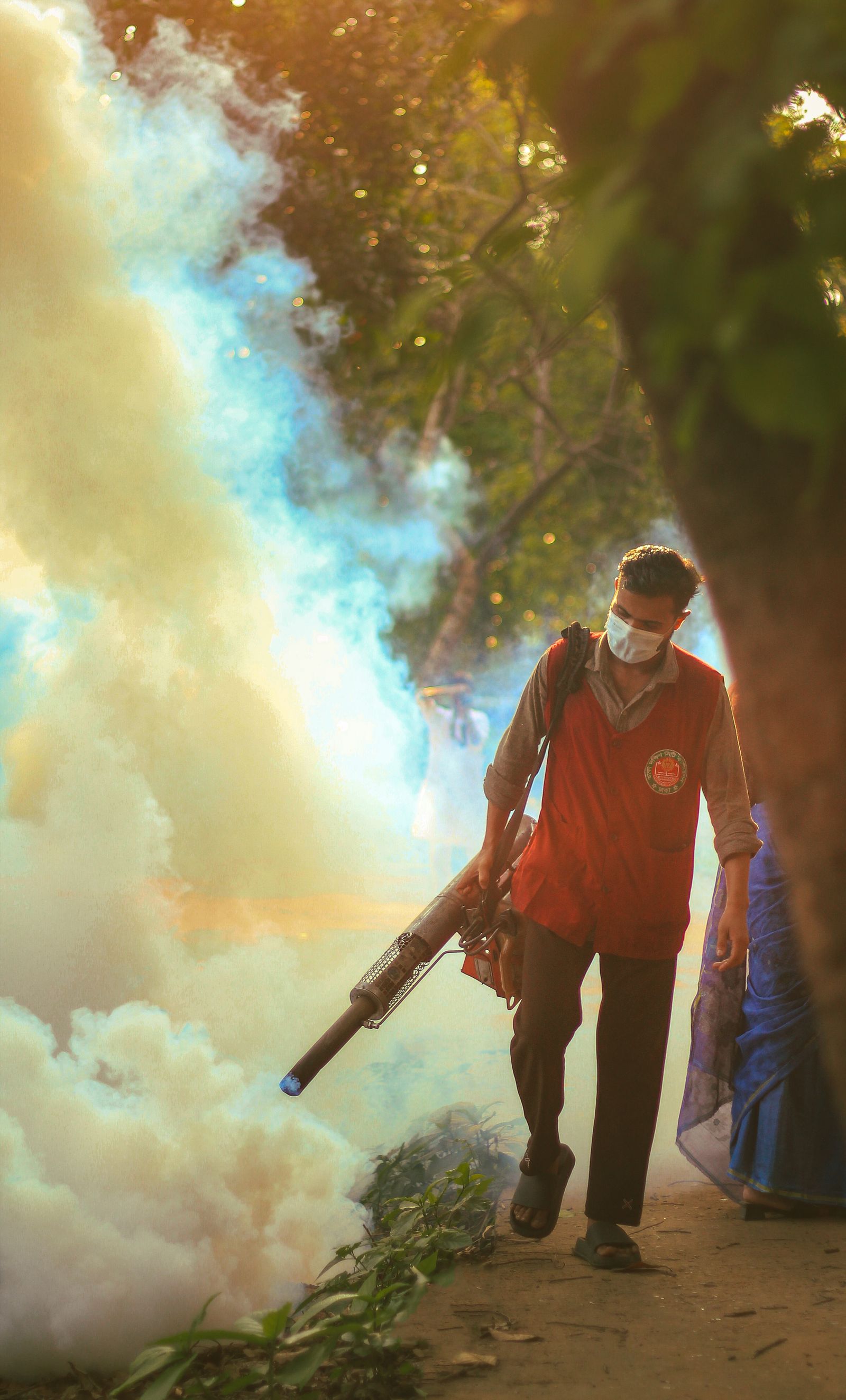A Lava Rock technician fogging a yard at golden hour to knock down a heavy pest population